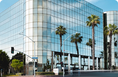 Modern glass corporate building with palm trees